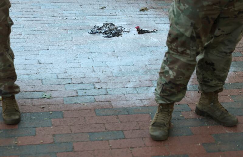 U.S. Army National Guard soldiers stand at the scene where a man burned a U.S. flag at the edge of Lafayette Park across from the White House in Washington, D.C., U.S., August 25, 2025.