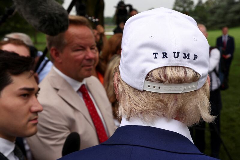 U.S. President Donald Trump speaks to members of the media as workers install a new flagpole on the South Lawn at the White House in Washington, D.C., U.S., June 18, 2025.  REUTERS/Kevin Lamarque