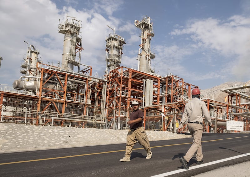 Iranian workers walk at a unit of South Pars Gas field in Asalouyeh Seaport, north of Persian Gulf, Iran November 19, 2015.