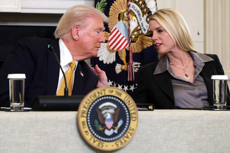 U.S. President Donald Trump speaks with Attorney General Pam Bondi as he delivers an announcement on his Homeland Security Task Force in the State Dinning Room of the White House on October 23, 2025 in Washington, DC.