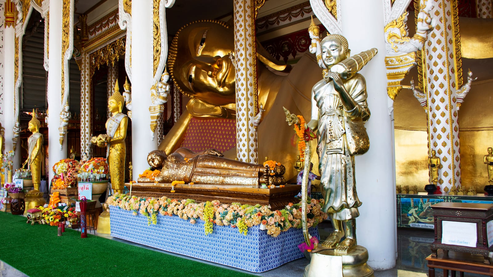 Holy ancient recline buddha statue in antique ubosot for thai travelers people travel visit and respect blessing deity angel at Wat Rat Prakhong Tham Temple on January 3, 2025 in Nonthaburi, Thailand