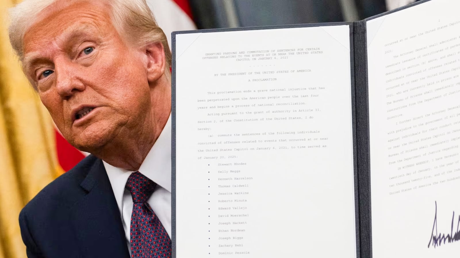 Donald Trump holding up an executive order.