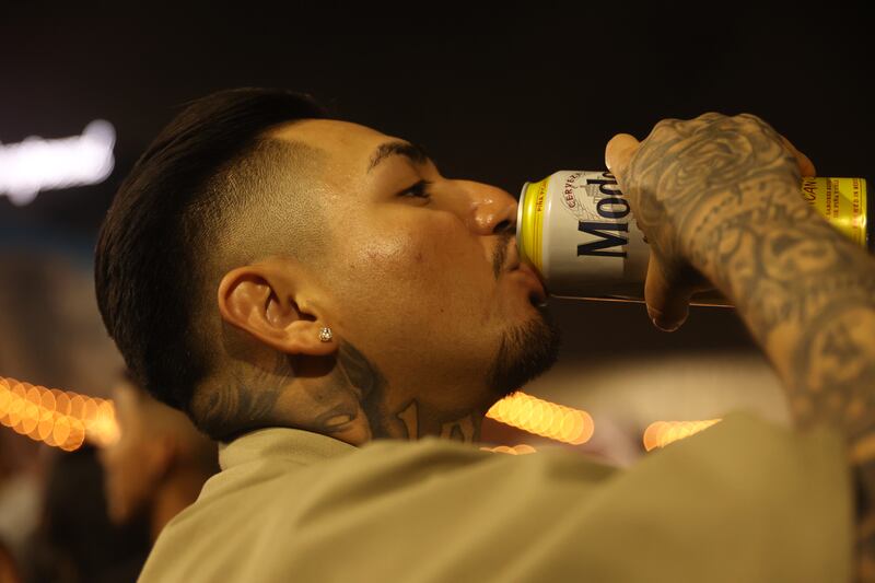 Man drinking Modelo beer.