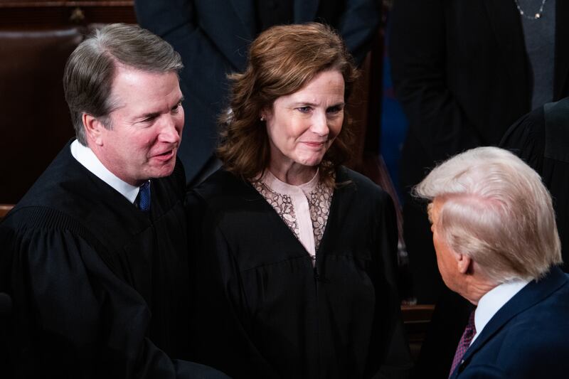 Supreme Court Justices Brett Kavanaugh and Amy Coney Barrett greet President Donald Trump after his address to a joint session of Congress in the House Chamber of the U.S. Capitol on Tuesday, March 4, 2025.