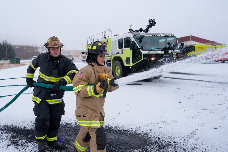 Kristi Noem participates in a firefighting drill with a training helicopter during a tour of U.S. Coast Guard Air Station in Kodiak, Alaska, on March 17, 2025.