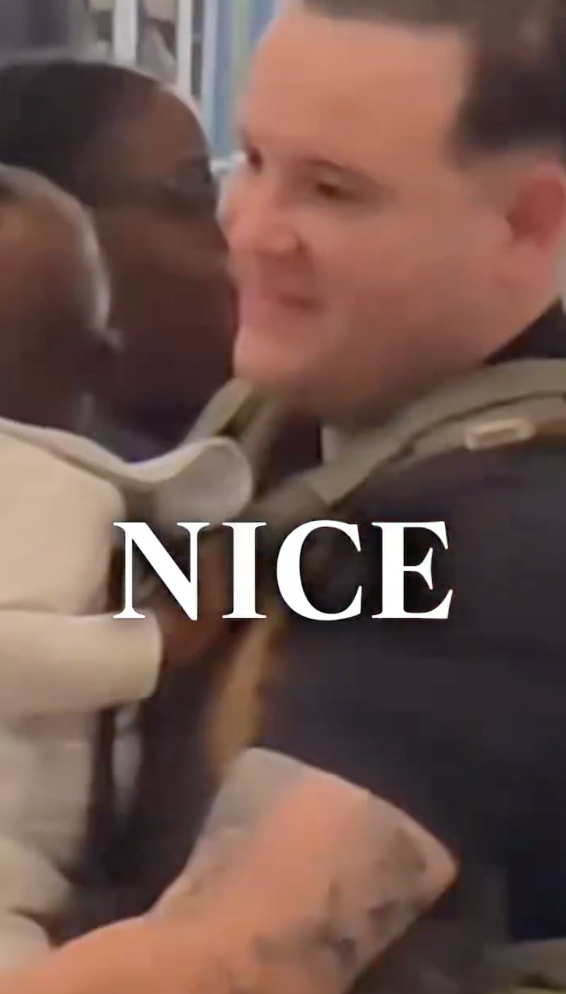 A still from the PR video released by ICE shows agents helping kids and families.