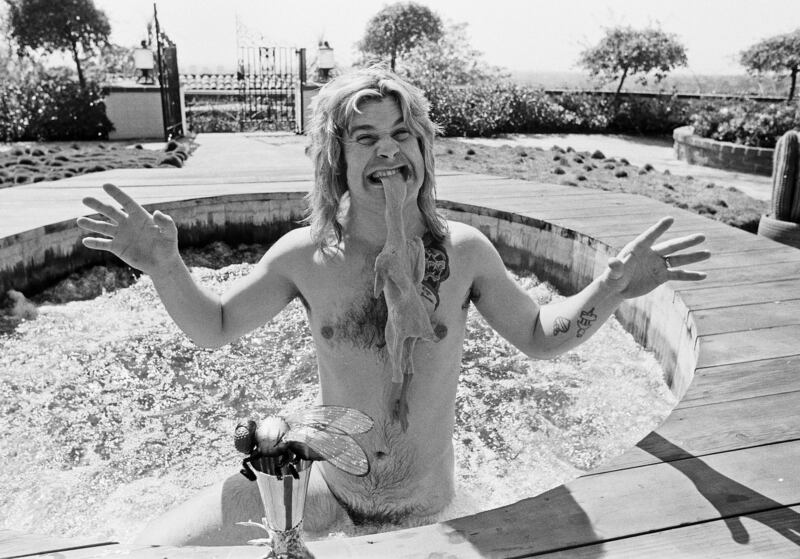 Ozzy Osbourne, former lead singer of Black Sabbath, in his hot tub at his luxury home in Goldwater Canyon, Beverly Hills, California biting the head of a rubber chicken on April 28, 1982.