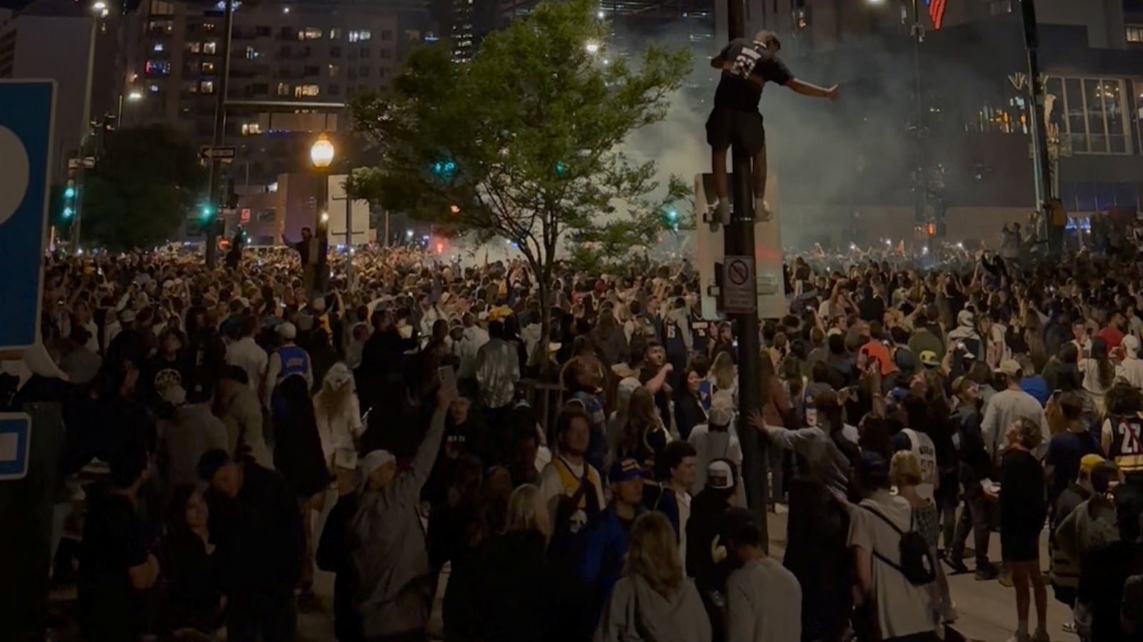 A view of crowd on the streets and fireworks during the celebration after Denver Nuggets won NBA title, in Downtown Denver, Colorado,U.S. June 12, 2023, in this screen grab obtained from a social media video.