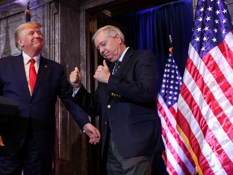 FILE PHOTO: U.S. Senator Lindsey Graham (R-SC) gestures, while standing next to former U.S. President Donald Trump, during Donald Trump's campaign stop to unveil his leadership team, at the South Carolina State House in Columbia, South Carolina, U.S., January 28, 2023. REUTERS/Shannon Stapleton/File Photo