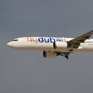 A Flydubai Boeing 737 MAX 8 performs a display flight at Al-Maktoum International Airport during the Dubai Airshow 2025 in Dubai on November 17, 2025.