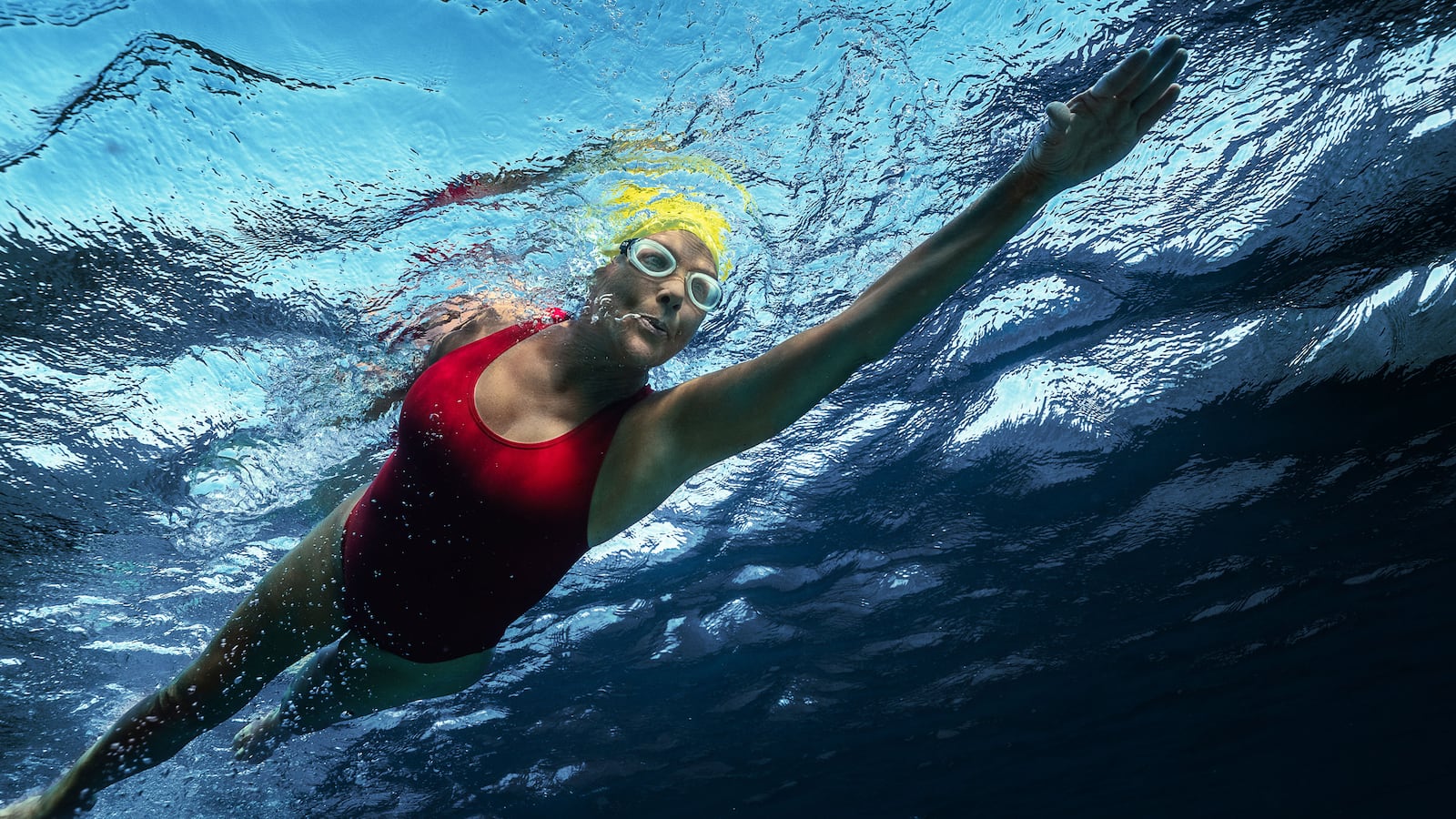 A photo including a film still of Annette Bening as Diana Nyad in the film NYAD on Netflix