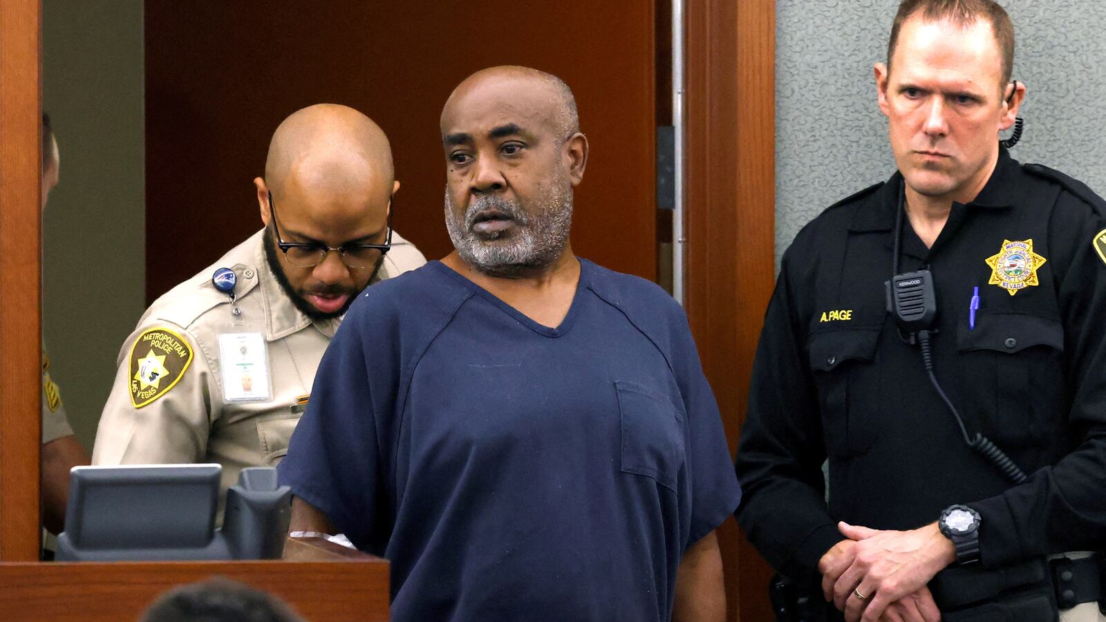 Duane Davis, a former gang member charged in the 1996 murder of hip-hop star Tupac Shakur, is led into the courtroom during his arraignment.