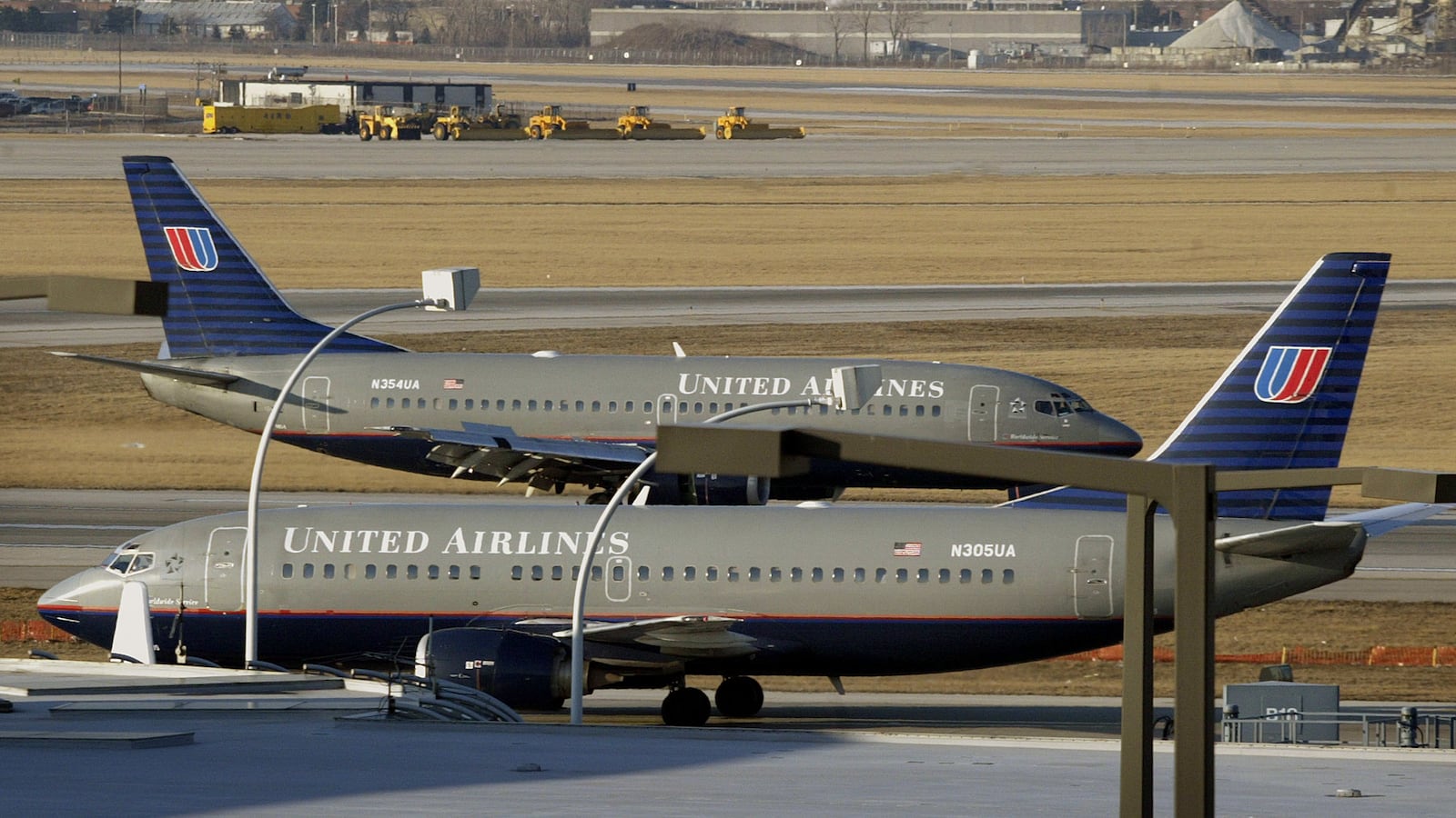 A picture of two United Airlines planes on the ground at O'Hare International Airport.