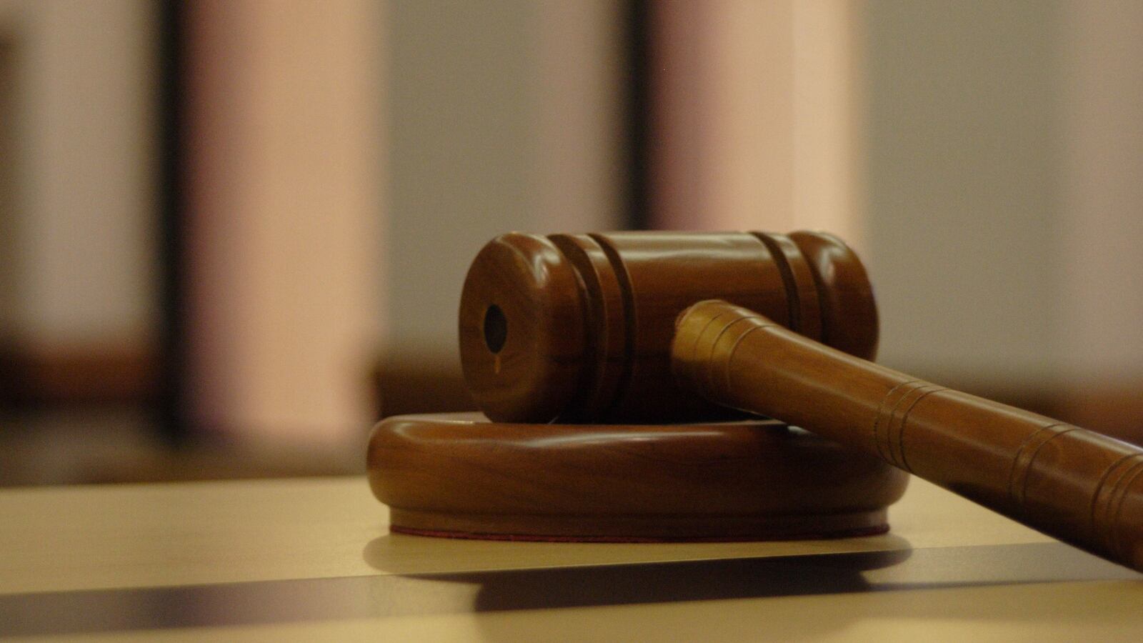 Wooden gavel on a counter.