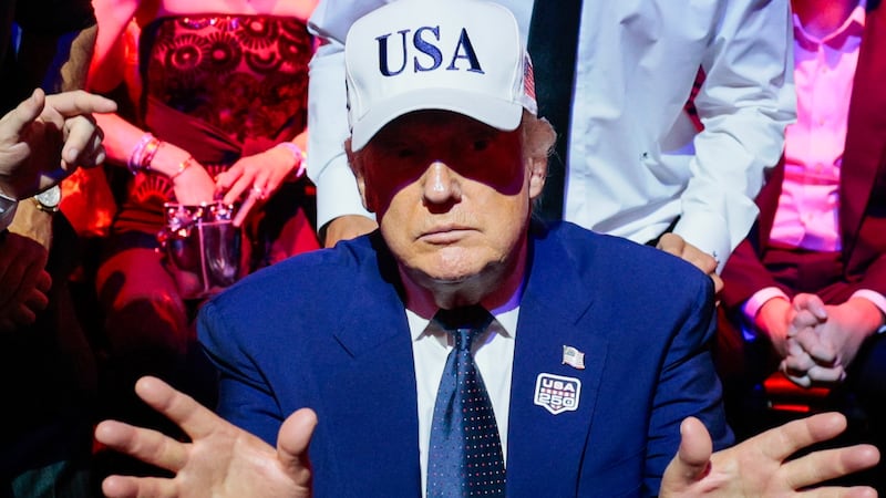 U.S. President Donald Trump gestures next to first lady Melania Trump during UFC Freedom 250 on the South Lawn of the White House on June 15, 2026 in Washington, DC.