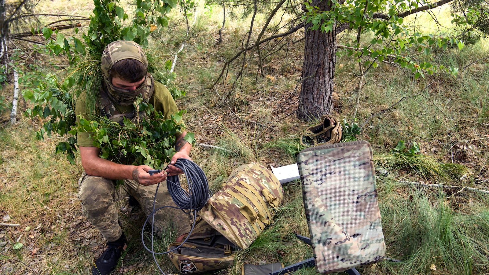 A Ukrainian soldier uses the Starlink system during military exercises in the Chernihiv region, Ukraine