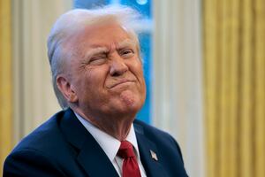 President Donald Trump reacts to a reporter's question from the Resolute Desk after signing an executive order to appoint the deputy administrator of the Federal Aviation Administration in the Oval Office at the White House on January 30, 2025 in Washington, DC. Trump also signed a memorandum ordering an immediate assessment of aviation safety and ordering an elevation of what he called “competence” over “D.E.I."