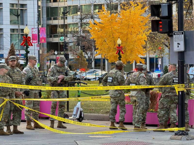 National Guard soldiers gather near a crime scene after a shooting in downtown Washington, DC, on November 26, 2025.