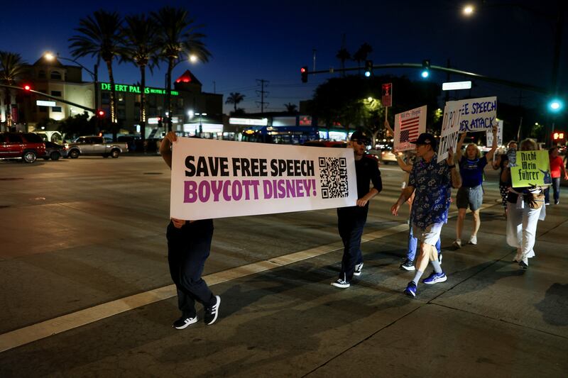 People take part in a protest outside Disneyland after Jimmy Kimmel's late-night talk show was suspended for remarks he made regarding Charlie Kirk's assassination, in Anaheim, California, U.S. September 19, 2025. REUTERS/David Swanson