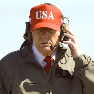 U.S. President Donald Trump observes naval flight demonstrations on the deck of the USS George H.W. Bush aircraft carrier.