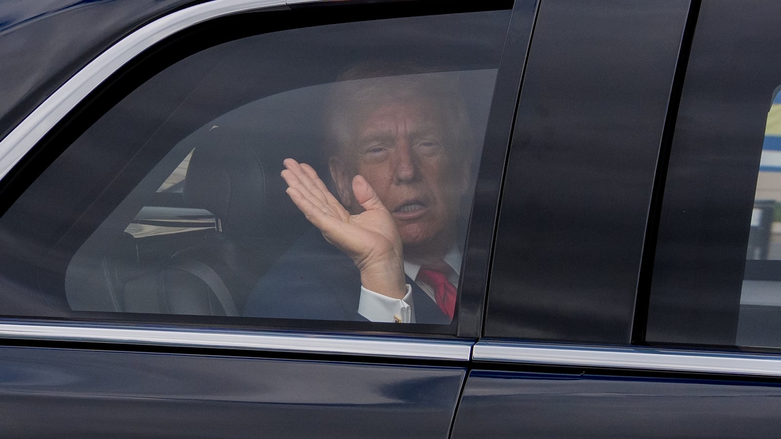 BETHESDA, MARYLAND - OCTOBER 10: U.S. President Donald Trump waves to members of the media as he is driven to Marine One while departing Walter Reed Medical Center on October 10, 2025 in Bethesda, Maryland. Trump traveled to Walter Reed to visit with troops and receive a medical check up. (Photo by Andrew Harnik/Getty Images)