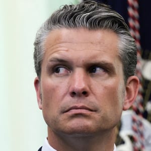 U.S. Secretary of Defense Pete Hegseth listens as U.S. President Donald Trump answers questions from the media after signing an executive order establishing the President's Military Spouse Commission to be chaired by Jennifer Rauchet, wife of Hegseth, in the Oval Office at the White House in Washington, D.C., U.S., August 3, 2026. REUTERS/Evelyn Hockstein