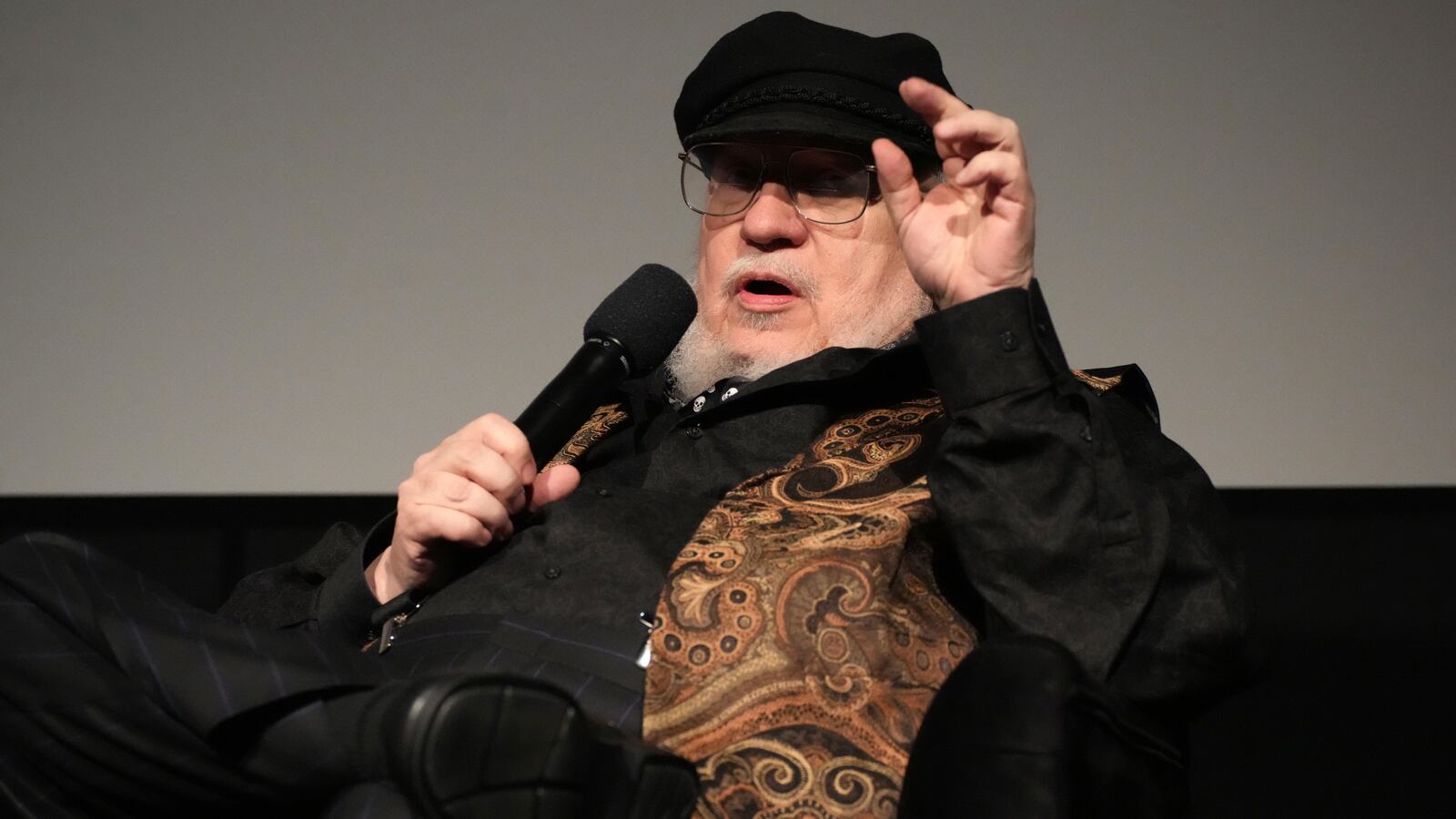 A picture of George R.R. Martin sitting.