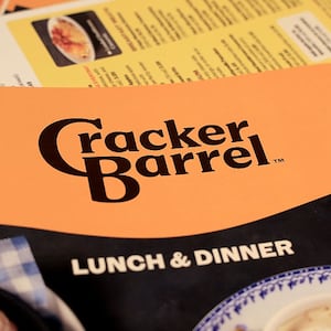 The new Cracker Barrel logo is seen on a menu inside the restaurant on August 21, 2025 in Pembroke Pines, Florida. The restaurant unveiled a new logo earlier this week as part of a larger brand refresh. The new logo removes the image of a man sitting next to a barrel and the phrase “old country store”. Now the logo will feature the words “Cracker Barrel” against a yellow background.