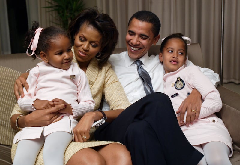 Barack Obama, his wife Michelle, and their daughters Malia and Sasha pose for a family photo in their Chicago hotel room in 2004.