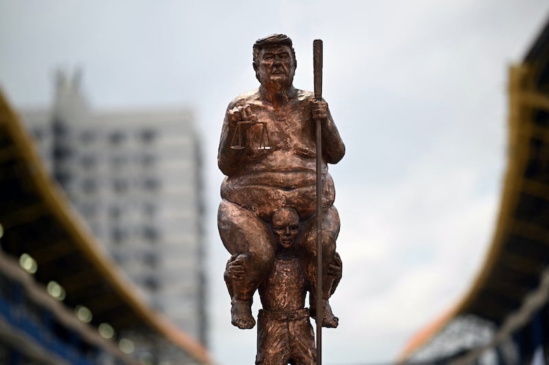 View of a copy of the sculpture by Danish artist Jens Galschiot, called King of Injustice -a satirical out-cry against US President Donald Trump and his policies against green transition- during the so-called "Great People's March" in the sidelines of the COP30 UN Climate Change Conference in Belem, Para State, Brazil on November 15, 2025. Thousands of people attended the march to demand "real solutions" to human-caused global warming , and which comes at the halfway point of contentious COP30 negotiations following two Indigenous-led protests that disrupted proceedings earlier in the week. (Photo by Mauro PIMENTEL / AFP) (Photo by MAURO PIMENTEL/AFP via Getty Images)
