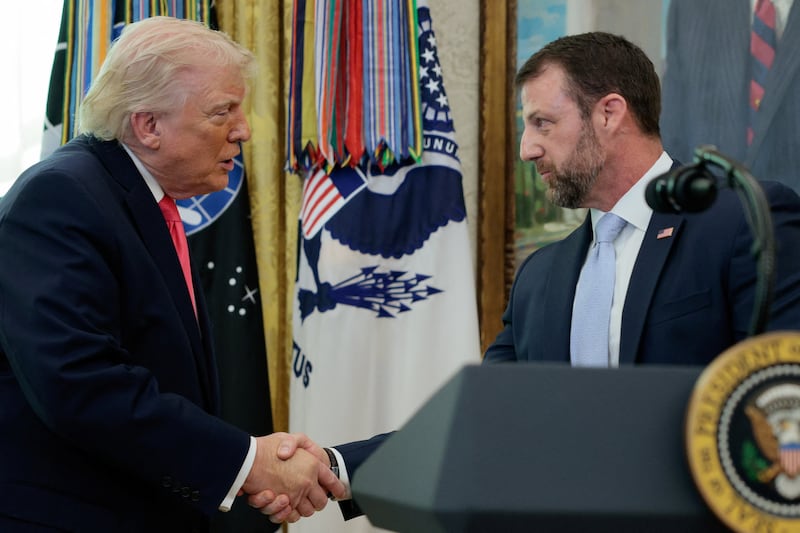 U.S. President Donald Trump shakes hands with Markwayne Mullin after he was sworn in as Department of Homeland Security (DHS) Secretary, at the White House in Washington, D.C., U.S., March 24, 2026. REUTERS/Evan Vucci     TPX IMAGES OF THE DAY