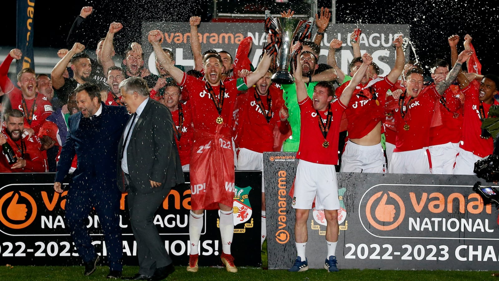 Wrexham's Ben Tozer and Luke Young lift the trophy as they celebrate winning the National League and promotion to League Two.
