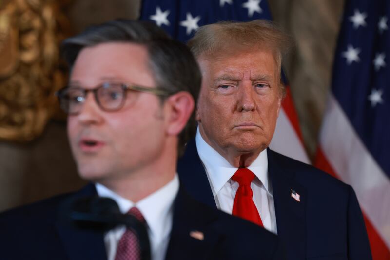 Donald Trump listens as Speaker of the House Mike Johnson (R-LA) speaks during a press conference at Mr. Trump's Mar-a-Lago estate on April 12, 2024, in Palm Beach, Florida.