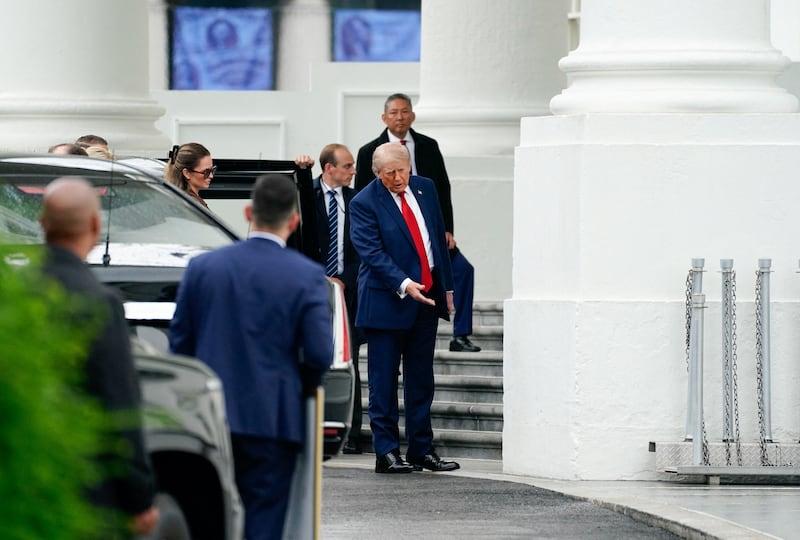 U.S. President Donald Trump examines the north columns of the White House, while returning from a Memorial Day event at Arlington National Cemetery, in Washington, D.C., U.S., May 25, 2026. REUTERS/Nathan Howard