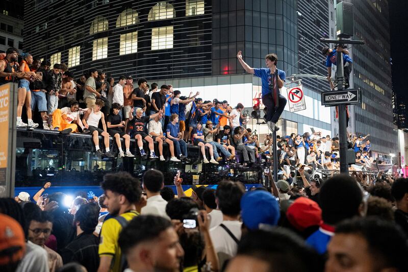 Fans celebrate the New York Knicks' win against the San Antonio Spurs in Game 5 of the NBA Finals, on a street near Madison Square Garden, in New York City, U.S., June 14, 2026.