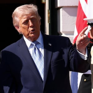 President Donald Trump speaks with Britain's King Charles as he arrives for afternoon tea on the South Lawn of the White House in Washington, D.C. on April 27, 2026.