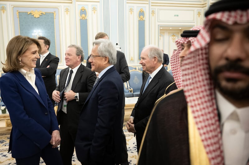 Alphabet chief investment officer Ruth Porat (L) and Nvidia CEO Jensen Huang (C) wait to meet the Saudi Crown Prince at the Royal Court in Riyadh on May 13, 2025.