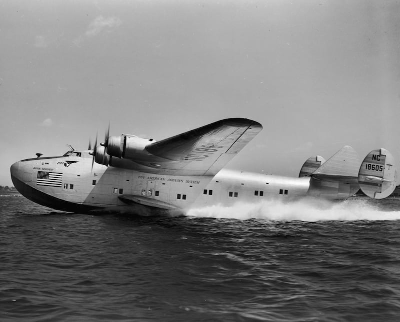 A Dixie Clipper seaplane from Pan American Airlines lands on water, 1940s.