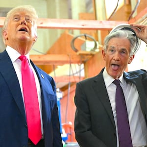 President Donald Trump speaks with Federal Reserve chair Jerome Powell (R) as he visits the Federal Reserve in Washington, DC, on July 24, 2025.