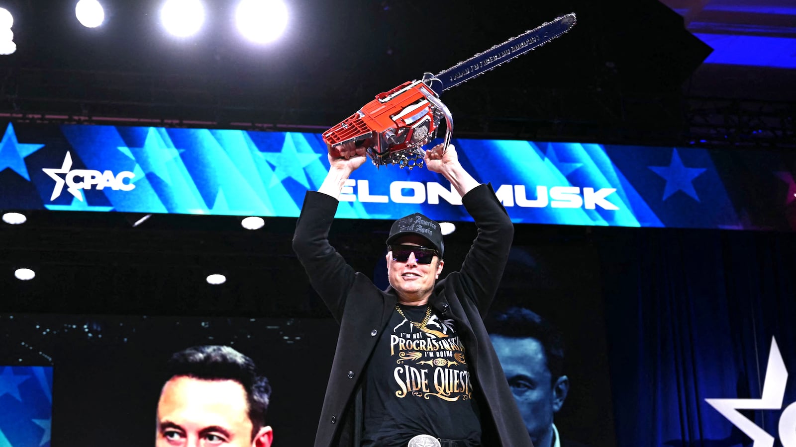 Elon Musk holds a chainsaw reading "Long live freedom, damn it" during the annual Conservative Political Action Conference (CPAC) at the Gaylord National Resort & Convention Center at National Harbor in Oxon Hill, Maryland, on February 20, 2025.