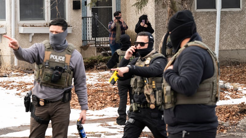 Observers film ICE agents as they hold a perimeter after one of their vehicles got a flat tire on Penn Avenue on February 5, 2026 in Minneapolis, Minnesota. Protests continue calling for an end to immigration raids in the Twin cities which have already resulted in the fatal shooting deaths of Alex Pretti, a VA nurse, and Renee Good, a mother of three, by federal agents.