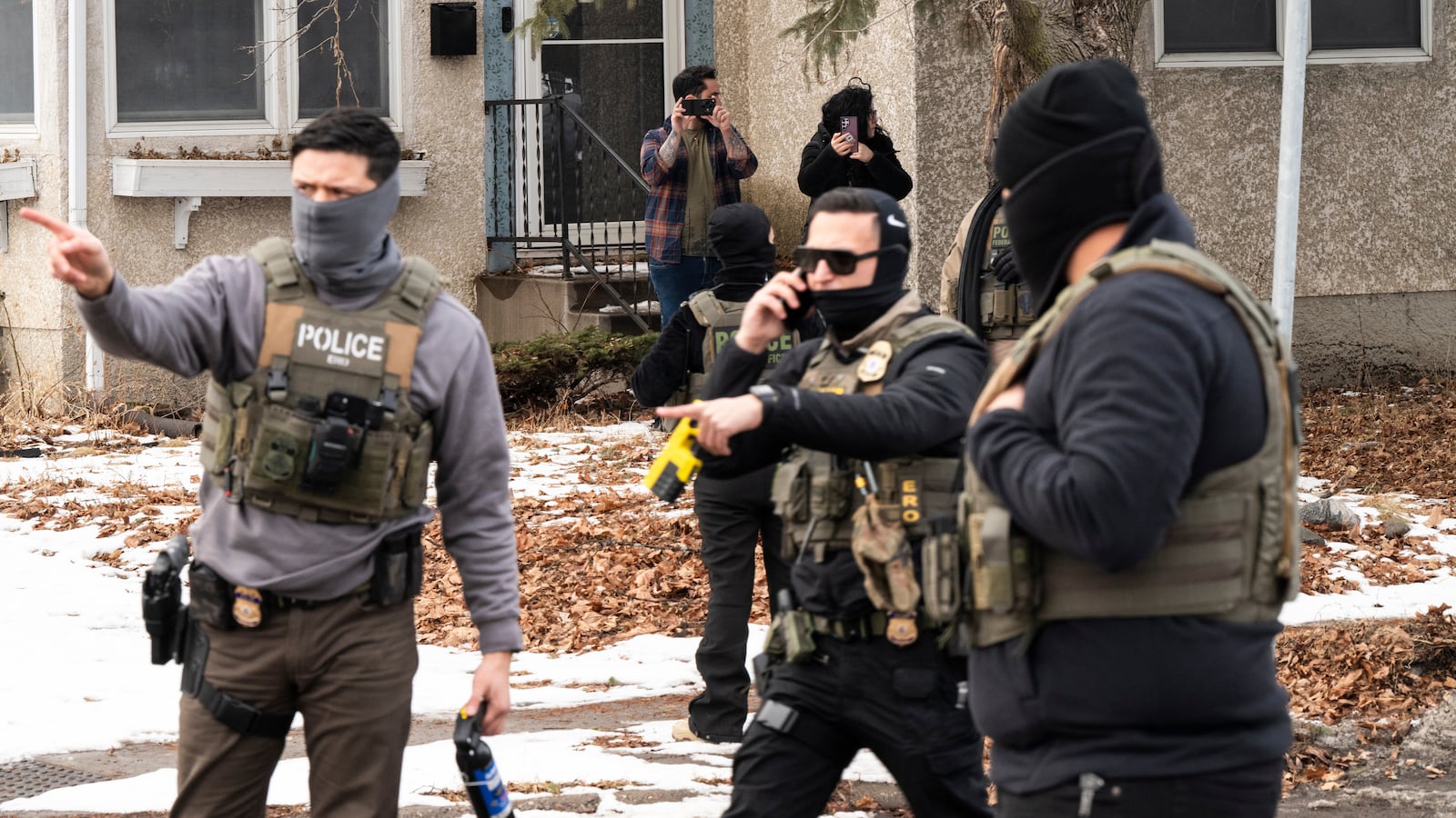 Observers film ICE agents as they hold a perimeter after one of their vehicles got a flat tire on Penn Avenue on February 5, 2026 in Minneapolis, Minnesota. Protests continue calling for an end to immigration raids in the Twin cities which have already resulted in the fatal shooting deaths of Alex Pretti, a VA nurse, and Renee Good, a mother of three, by federal agents.