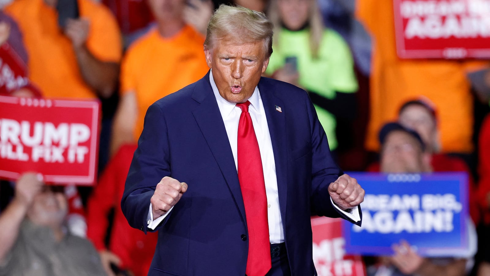 Donald Trump dances as he walks on stage during a campaign rally at Van Andel Arena in Grand Rapids, Michigan on November 5, 2024.