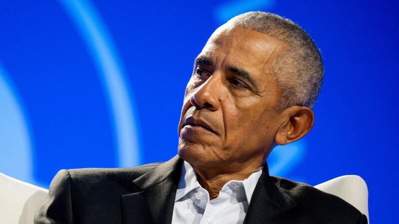 Former U.S. president Barack Obama listens to speakers on a panel at the Obama Foundation Democracy Forum.