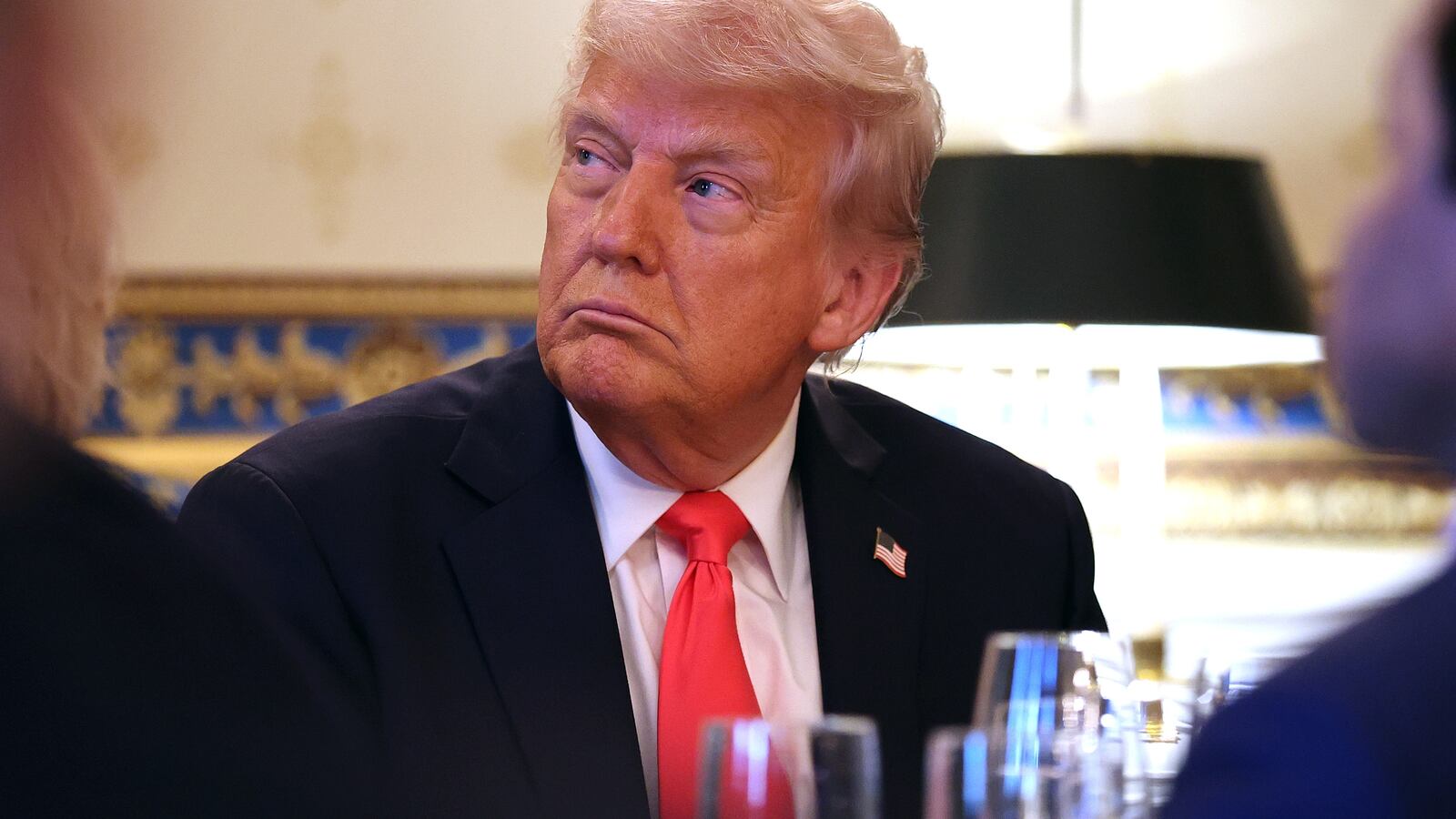 President Donald Trump looks on before he delivers remarks during an Easter Prayer Service and Dinner in the Blue Room of the White House.