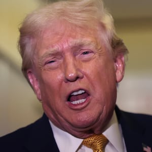 Donald Trump speaks to the media aboard Air Force One en route to Washington, DC on January 04, 2026. Trump is returning to the White House after giving the order for the United States law enforcement to capture Venezuelan President Nicolás Maduro and his wife. (Photo by Joe Raedle/Getty Images)