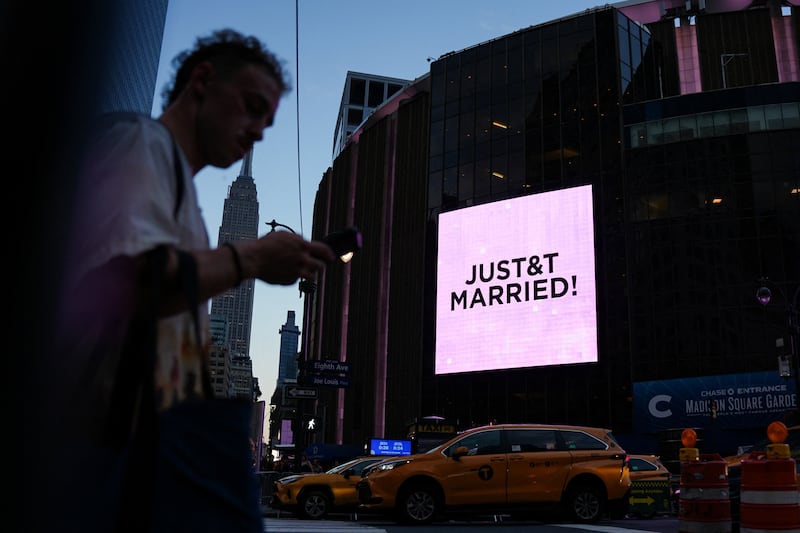 A screen displays a message referencing singer Taylor Swift and Travis Kelce outside Madison Square Garden.