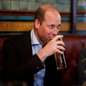 Britain's William, Prince of Wales drinks a pint of cider as he chats to local business people inside the Dog and Duck pub in Soho ahead of King Charles' coronation, in London, May 4, 2023.