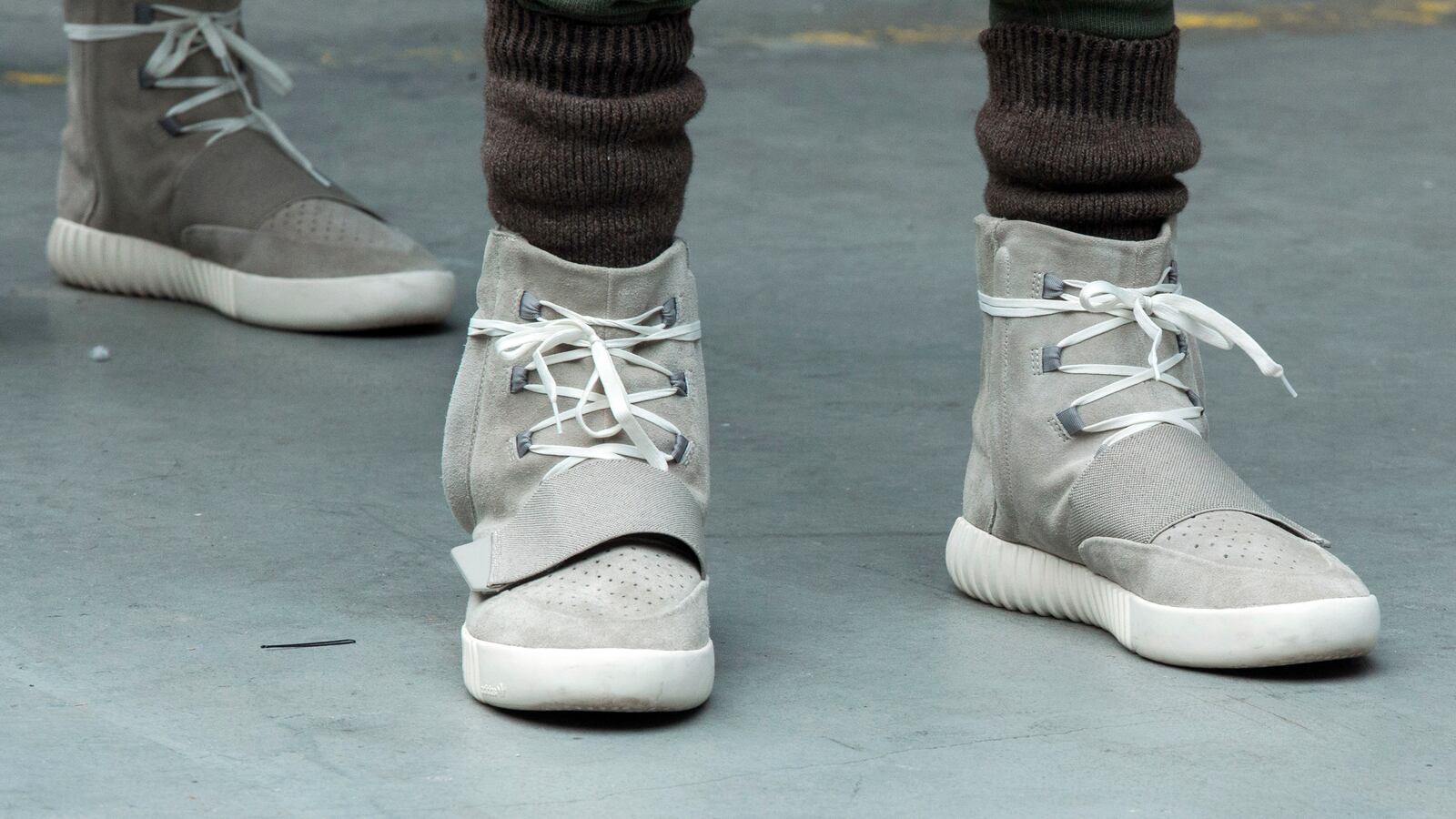 A pair of Yeezy sneakers worn by a model
