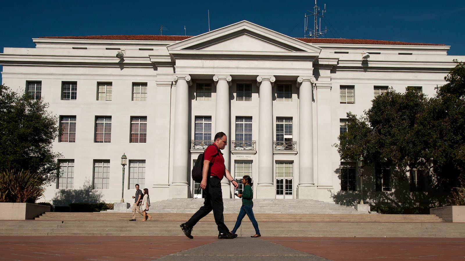 Pedestrians pass Sproul Hall, the University of California at Berkeley's administration building.